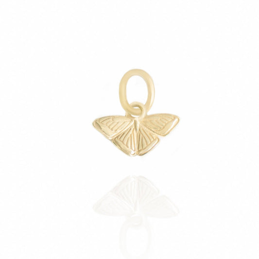 Gold butterfly pendant on a white background